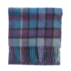 A folded plaid scarf in shades of purple, blue, and gray with fringed edges, shown on a plain white background.